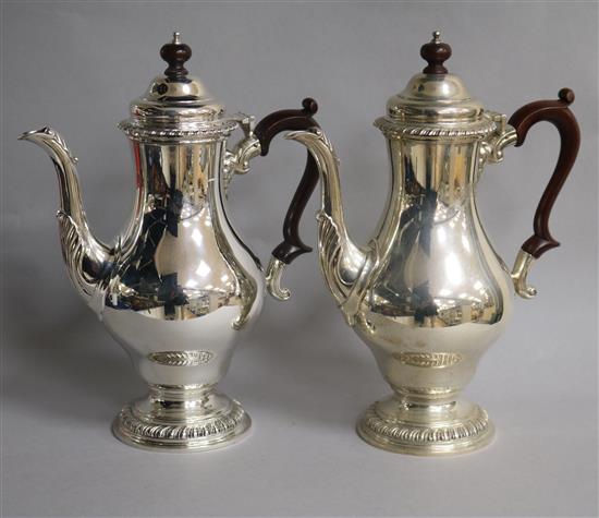 A pair of 1960s silver coffee pots by William Comyns & Sons Ltd, London, 1968, gross 60.5 oz.